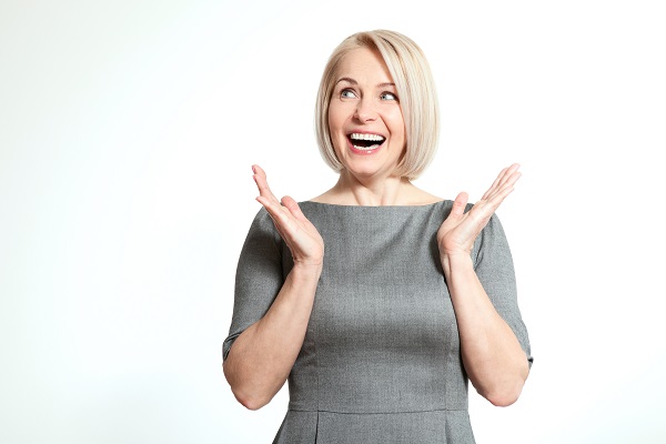 Attractive middle aged woman clapping