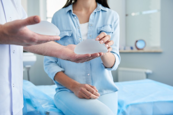 Woman and doctor looking at breast implant options