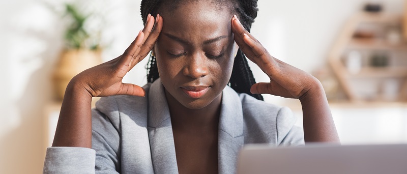 A young woman experiencing symptoms of illness in the workplace