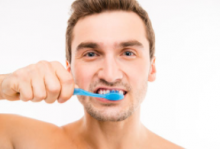 Adult Male brushing his teeth