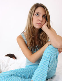 young woman thinking about sleep apnea issues