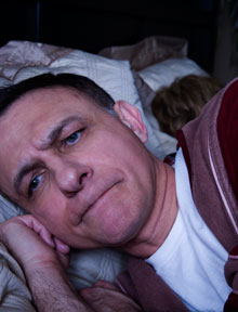 man with sleep apnea having restless night