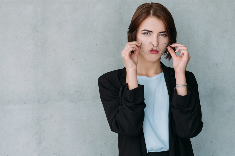 Woman removing glasses