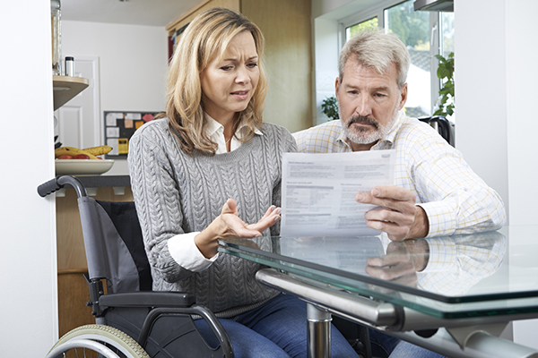 Woman in British Columbia reads disability insurance denial letter