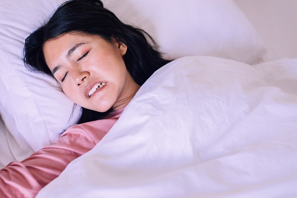 Woman grinding teeth while sleeping