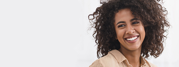 Salt Lake City woman smiles after full mouth restoration and cosmetic dentistry.